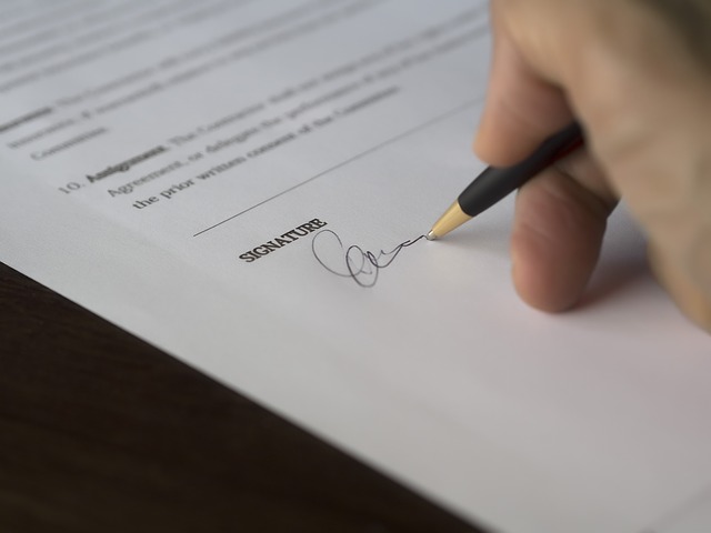 Person signing a document in a benefit fraud